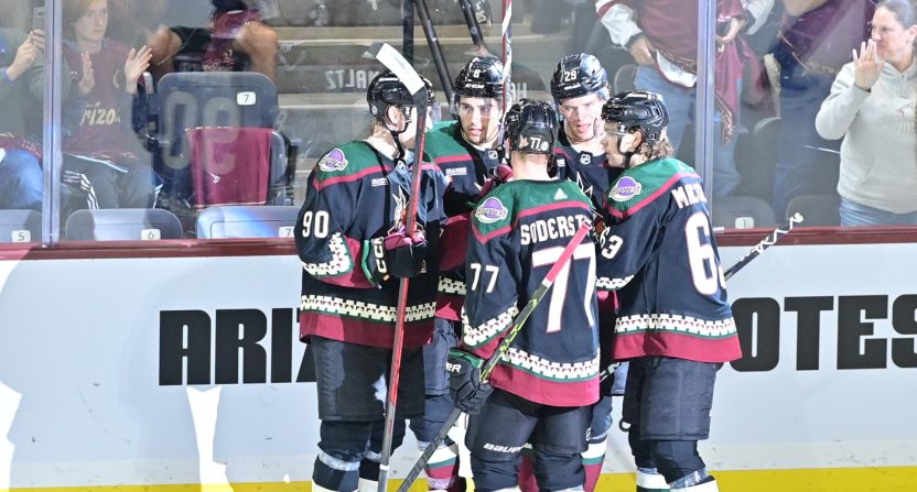 Arizona Coyotes center Nick Schmaltz (8) celebrates with teammates after scoring a goal in the third period against the Vancouver Canucks